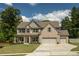 Beautiful two-story home with brick and siding exterior, two-car garage, and a well-manicured front yard at 2106 Sycamore Ln, Loganville, GA 30052