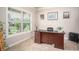 Cozy home office featuring a wooden desk, plush carpeting, and ample natural light for productivity at 2106 Sycamore Ln, Loganville, GA 30052