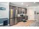 Kitchen featuring stainless steel appliances, gray cabinets, and granite countertops at 2106 Sycamore Ln, Loganville, GA 30052