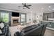 Open-concept living room with a fireplace, modern decor, and an adjacent kitchen perfect for entertaining at 2106 Sycamore Ln, Loganville, GA 30052