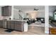 Open-concept space with kitchen island flowing into the living room with leather furniture at 2106 Sycamore Ln, Loganville, GA 30052