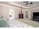 Main bedroom with view into living area, and a fireplace, and four poster bed at 2106 Sycamore Ln, Loganville, GA 30052
