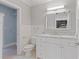 Bright bathroom featuring marble countertop, white cabinets, and adjacent walk-in closet at 2255 Peachtree Ne Rd # 426, Atlanta, GA 30309