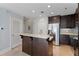 Well-lit kitchen with a stylish island, stainless steel appliances, and dark wood cabinetry at 2255 Peachtree Ne Rd # 426, Atlanta, GA 30309