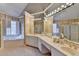 The bathroom has dual vanities, a soaking tub, and a glass-enclosed shower at 235 Haydens Walk Ct, Johns Creek, GA 30022