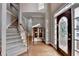 Grand foyer featuring hardwood floors, staircase, and a decorative glass front door with side lights at 235 Haydens Walk Ct, Johns Creek, GA 30022