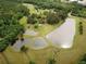 Picturesque aerial view featuring three ponds surrounded by lush greenery and trees at 7275 Bishop Rd, Fairburn, GA 30213