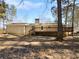 Backyard with brick home, expansive back deck, and mature trees at 8005 Bamby Ln, Jonesboro, GA 30236
