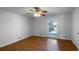 Bright bedroom with hardwood floors, ceiling fan, closet, window view of landscaped yard at 8005 Bamby Ln, Jonesboro, GA 30236