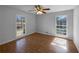 Light-filled bedroom featuring hardwood floors, large windows, and a ceiling fan at 8005 Bamby Ln, Jonesboro, GA 30236