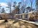 Charming ranch-style home featuring a brick facade, blue shutters, and a well-manicured front yard, all under a bright blue sky at 8005 Bamby Ln, Jonesboro, GA 30236