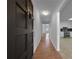 Inviting hallway with hardwood floors leading from a solid door entrance to a bright kitchen and living area, enhancing flow at 8005 Bamby Ln, Jonesboro, GA 30236
