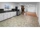 Functional kitchen connected to a cozy living area with a stone fireplace, complete with modern appliances and ample counter space at 8005 Bamby Ln, Jonesboro, GA 30236