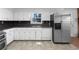 Well-lit kitchen with white cabinetry, stainless steel appliances, and a stainless steel sink below the window at 8005 Bamby Ln, Jonesboro, GA 30236