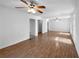 Spacious living room featuring wood floors, white walls, ceiling fan, and good natural light at 8005 Bamby Ln, Jonesboro, GA 30236