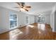 Spacious living room boasting glossy hardwood floors and multiple windows that flood the area with natural light, creating an airy feel at 8005 Bamby Ln, Jonesboro, GA 30236