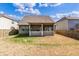 View of home backyard featuring screened in porch, lawn, and perimeter wood fence at 116 Holly View Ln, Canton, GA 30114