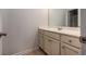 Neutrally painted bathroom with long vanity cabinet, mirror, and tiled floor at 116 Holly View Ln, Canton, GA 30114