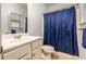 Standard bathroom with tiled floors, blue shower curtain, and vanity with chrome faucet at 116 Holly View Ln, Canton, GA 30114