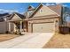 Charming home with a brick facade, two-car garage, manicured lawn, and covered entryway at 116 Holly View Ln, Canton, GA 30114