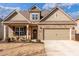 Charming brick home with a well-manicured lawn, inviting front porch, and attached two-car garage at 116 Holly View Ln, Canton, GA 30114