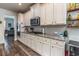 Bright kitchen showcasing white cabinets, granite counters, and stainless steel appliances at 116 Holly View Ln, Canton, GA 30114