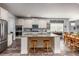 Bright kitchen with a large island, granite countertops, stainless steel appliances, and stylish pendant lighting at 116 Holly View Ln, Canton, GA 30114