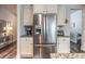 Stainless steel refrigerator complemented by custom cabinets and granite countertops at 116 Holly View Ln, Canton, GA 30114