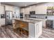 Spacious kitchen with stainless steel appliances, a large island, and ample storage in classic white cabinets at 116 Holly View Ln, Canton, GA 30114