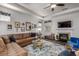 Bright and modern living room featuring a fireplace, comfortable seating, a ceiling fan, and decorative accents at 116 Holly View Ln, Canton, GA 30114