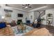 Comfortable living room featuring a fireplace, seating, ceiling fan, and decor; staircase visible in background at 116 Holly View Ln, Canton, GA 30114