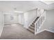 Finished basement with neutral carpet, white trim, and a stairway leading to the upper level at 2653 Del Ridge Dr, Douglasville, GA 30135