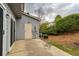 The home has a modest concrete patio and mature shrubs lining the back of the property at 3374 Thornbridge Dr, Powder Springs, GA 30127