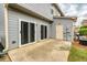 Concrete patio with sliding glass doors provides an outdoor entertaining space and access to the home at 3374 Thornbridge Dr, Powder Springs, GA 30127