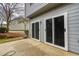 This home has a concrete patio and sliding glass doors offering access to the backyard at 3374 Thornbridge Dr, Powder Springs, GA 30127