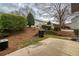 View of backyard patio and pine straw landscaping against a cloudy sky at 3374 Thornbridge Dr, Powder Springs, GA 30127