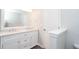 Bright bathroom featuring a white double vanity, marble countertop, and a private toilet at 3374 Thornbridge Dr, Powder Springs, GA 30127