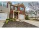 Charming brick townhome featuring a one car garage, inviting curb appeal, and manicured landscaping at 3374 Thornbridge Dr, Powder Springs, GA 30127