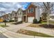 Street view of townhomes featuring attached garages, sidewalks and lush landscaping for curb appeal at 3374 Thornbridge Dr, Powder Springs, GA 30127