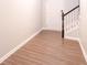 Spacious foyer featuring wood-look floors, a staircase, and a front door at 3374 Thornbridge Dr, Powder Springs, GA 30127