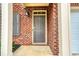 Close-up of a front door showcasing the brick facade and covered entryway of the home at 3374 Thornbridge Dr, Powder Springs, GA 30127