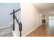 Open hallway with hardwood floors, staircase, and a view of the living room with fireplace at 3374 Thornbridge Dr, Powder Springs, GA 30127