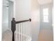 Upstairs hallway featuring railing and a window at 3374 Thornbridge Dr, Powder Springs, GA 30127