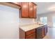 Galley kitchen with wood cabinets and granite countertops at 3374 Thornbridge Dr, Powder Springs, GA 30127