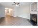 Inviting living room featuring a fireplace, wood-look floors, and plenty of natural light at 3374 Thornbridge Dr, Powder Springs, GA 30127