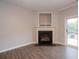 A well-lit living room featuring a fireplace and sliding glass doors to the outside at 3374 Thornbridge Dr, Powder Springs, GA 30127