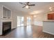 Spacious living room with a cozy fireplace, wood-look floors, and sliding glass doors at 3374 Thornbridge Dr, Powder Springs, GA 30127