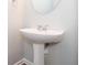 Elegant pedestal sink in a well-lit powder room featuring neutral wall color at 3374 Thornbridge Dr, Powder Springs, GA 30127