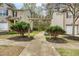 Charming townhomes with a wooden pergola leading to a walkway at 3374 Thornbridge Dr, Powder Springs, GA 30127