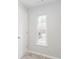 Bright bedroom featuring neutral walls, a large window, and a door at 3374 Thornbridge Dr, Powder Springs, GA 30127